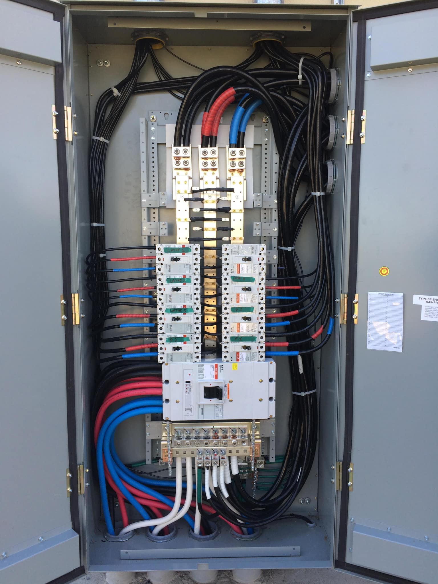 C&G Electric Inc commercial Eaton distribution panel — open enclosure showing clean red, blue, and black wiring to main breaker and branch circuits, expert workmanship on a North Texas commercial job