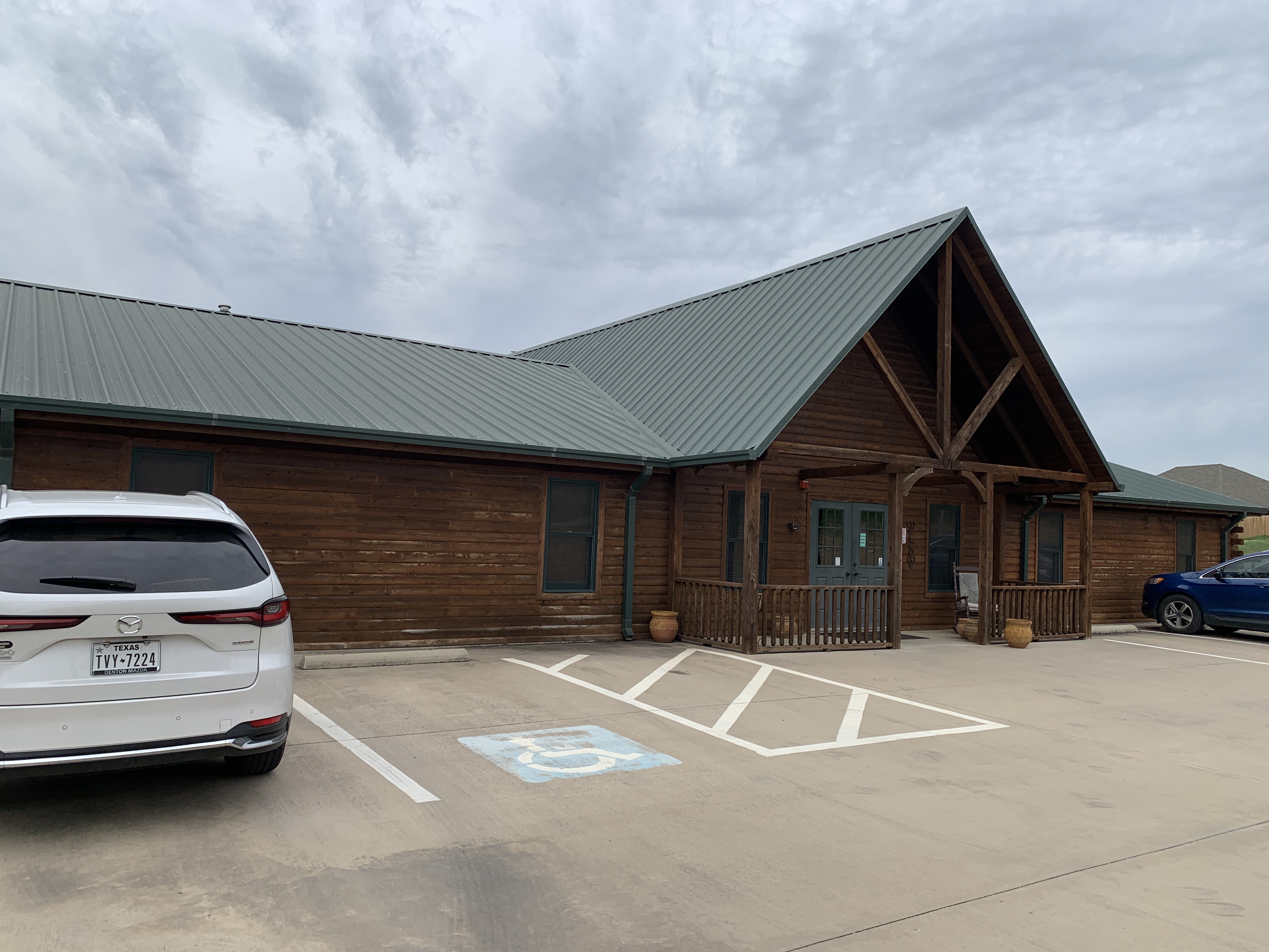 C&G Electric Inc office building at 2901 FM 156 N., Krum, TX — log cabin exterior with parking lot, home of this licensed North Texas electrical contractor since 1991